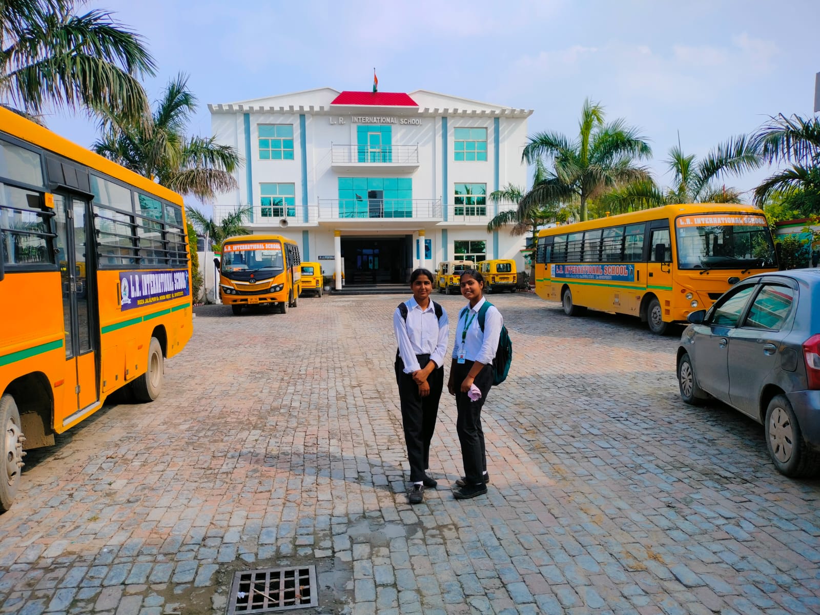 two children standing outside the school.